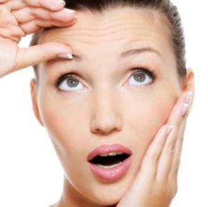 Woman touching her forehead lines