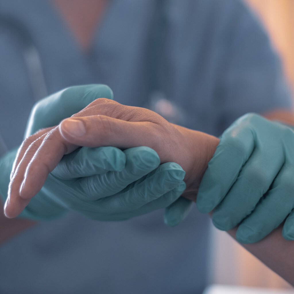 Nurse holding a patient's hand